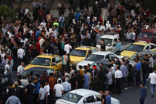 Dozens of Syrians wait at the President's Bridge in Damascus for relatives they hope would be among those released from prison May 3, 2022, on the second day of the Muslim Fitr holiday. A newly released video taken in 2013 showed blindfolded men who were thrown into a large pit and shot dead by Syrian agents, who then set the bodies on fire. The video stirs new fears over the fate of tens of thousands who went missing during Syria's long-running conflict and serves as a grim reminder of the war'