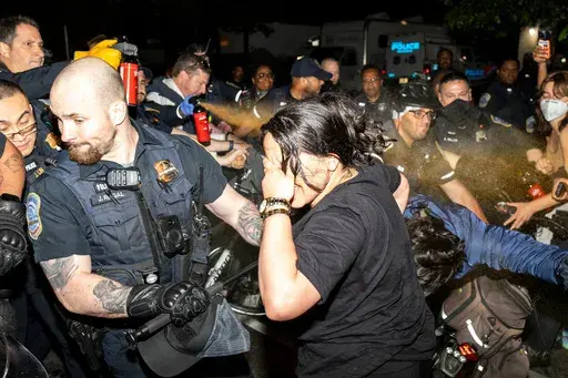 Officers of the Metropolitan Police Department pepper spray demonstrators at George Washington University in Washington, May 8, 2024. More than 3,200 people were arrested on campuses this spring during a wave of pro-Palestinian tent encampments protesting the war in Gaza. (Sage Russell/GW Hatchet via AP, File)