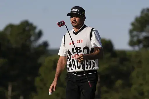 Jason Day, of Australia, waves after making a putt on the 18th hole during the weather delayed first round round at the Masters golf tournament at Augusta National Golf Club, April 12, 2024, in Augusta, Ga. (AP Photo/George Walker IV, file)