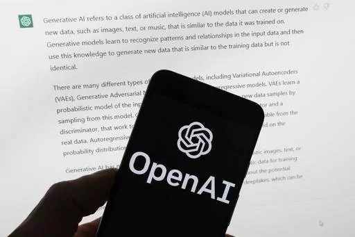 The OpenAI logo is seen on a mobile phone in front of a computer screen displaying output from ChatGPT, March 21, 2023, in Boston. The U.S. Federal Trade Commission has launched an investigation into ChatGPT creator OpenAI and whether the artificial intelligence company violated consumer protection laws by scraping public data and publishing false information through its chatbot, according to reports in the Washington Post and the New York Times. (AP Photo/Michael Dwyer, File)