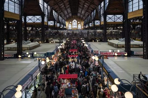 Customers purchase food in Budapest's Grand Market Hall on Saturday, April 8, 2023. Food prices have risen dramatically across Europe in recent months, but Hungary is facing the biggest spike. That's hitting consumers hard, forcing them to change what kind of food they buy and how much of it they can afford. Businesses also are rethinking what they sell as food prices in Hungary surged 45% over the year. In the European Union, those costs jumped 19.6%. (AP Photo/Denes Erdos)