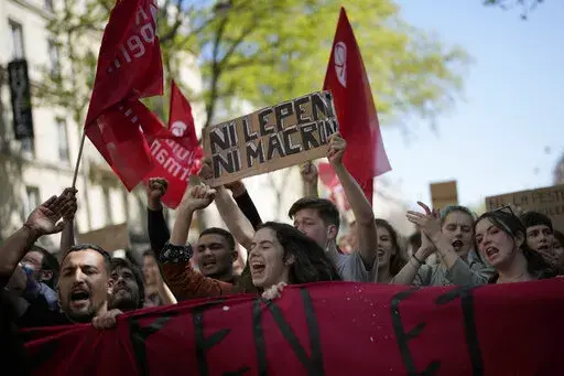 A demonstrator holds a banner that reads: 'Neither Macron nor Le Pen', during a protest in Paris, April 16, 2022. Disgruntled left-wing voters whose candidates were knocked out in the first round of France's election are the wild cards in the winner-takes-all runoff on Sunday April 24, 2022. How they vote — or don’t vote — will in large part determine whether incumbent Emmanuel Macron gets a second five-year term or cedes the presidential Elysee Palace to far-right nationalist Marine Le Pe