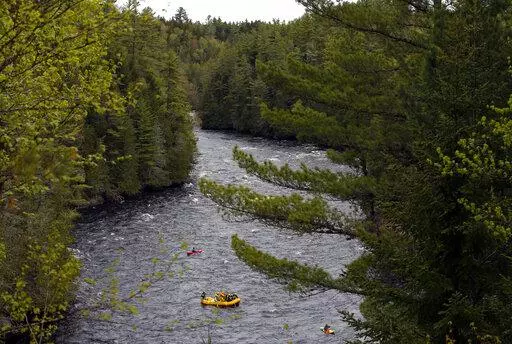 Whitewater rafters paddle on the Kennebec River in The Forks, Maine, on May 28, 2019. On the Kennebec River, conservation groups and state environmental agencies are pushing for the removal of four hydropower dams that block endangered Atlantic salmon from reaching habitat. The dams generate about 5% of the state’s renewable energy. (AP Photo/Robert F. Bukaty, File)