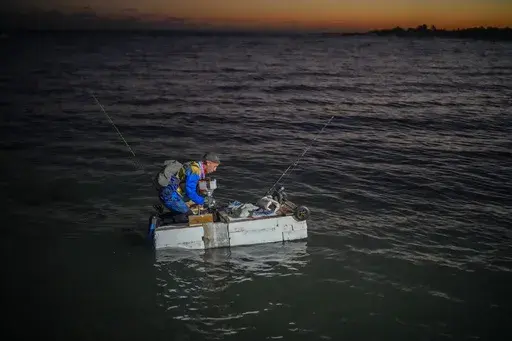 A man on a makeshift "corcho" raft prepares to fish at dawn in Cojimar, east of Havana, Cuba, Wednesday, March 12, 2025. (AP Photo/Ramon Espinosa)
