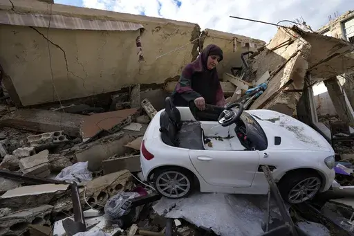 Mariam Kourani removes a toy car from the rubble of her destroyed house after returning with her family to the Hanouiyeh village in southern Lebanon, on Nov. 28, 2024, following a ceasefire between Israel and Hezbollah. (AP Photo/Hussein Malla, File)