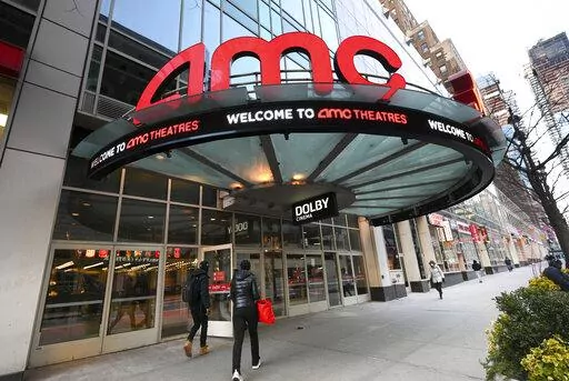 People walk by the AMC 34th Street theater on March 5, 2021, in New York. AMC Theaters, the nation's largest movie theater chain, on Monday unveiled a new pricing scheme in which seat location determines how much your movie ticket costs. Seats in the middle will cost a dollar or two more, while seats in the front row will be slightly cheaper. (Photo by Evan Agostini/Invision/AP, File)