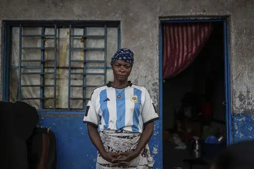 Louise Sabina, 39, poses for a photo Tuesday, Feb. 18, 2025 in a Goma, eastern Congo school where she and her 10 children found shelter after her soldier husband was sent to Rumangabo for mixing and integration into the M23 rebel forces. (AP Photo/Moses Sawasawa)