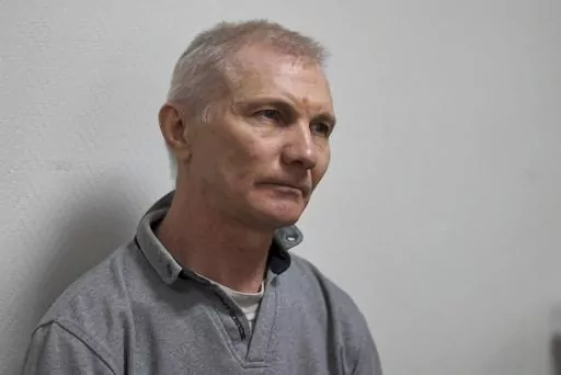 Alexei Moskalyov sits in a courtroom in Yefremov, Tula region, some 300 kilometers (186 miles) south of Moscow, Russia, Monday, March 27, 2023. A court in Russia on Tuesday convicted a single father over social media posts criticizing the war in Ukraine and sentenced him to two years in prison — a case brought to the attention of authorities by his daughter's drawings against the invasion at school, according to the man's lawyer and local activists. The 54-year-old Moskalyov, a single father o