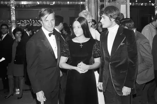 "Romeo and Juliette" movie director Franco Zeffirelli, left, actors Olivia Hussey, center, and Leonard Whiting are seen after the Parisian premiere of the film in Paris on Sept. 25, 1968. (AP Photo/Eustache Cardenas, File)