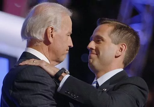 Then-Democratic vice presidential candidate Sen. Joe Biden, D-Del., left, embraces his son Beau Biden on stage at the Democratic National Convention in Denver, Aug. 27, 2008. (AP Photo/Charles Dharapak, File)