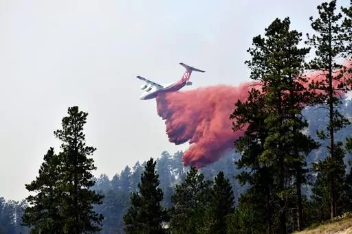 An aircraft drops fire retardant to slow the spread of the Richard Spring fire, east of Lame Deer, Mont., on Aug. 11, 2021. A legal dispute in Montana could drastically curb the government’s use of aerial fire retardant to combat wildfires. Environmentalists have sued the U.S. Forest Service over waterways being polluted with the potentially toxic red slurry that’s dropped from aircraft. Forest Service officials have acknowledged more than 200 cases of retardant landing in water. (AP Photo/M
