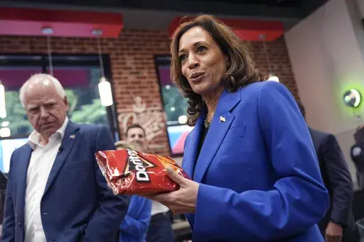 Democratic presidential nominee Vice President Kamala Harris holds a bag of Doritos chips as Democratic vice presidential nominee Minnesota Gov. Tim Walz looks on at Sheetz convenience store during a campaign stop, Aug. 18, 2024, in Coralpolis, Pa. (AP Photo/Julia Nikhinson, File)