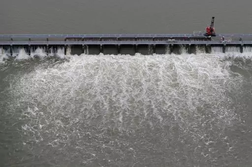Workers open bays of the Bonnet Carre Spillway to divert rising water from the Mississippi River to Lake Pontchartrain, upriver from New Orleans, in Norco, La., May 10, 2019. The U.S. Army Corps of Engineers appealed a federal judge’s ruling Monday, March 20, 2023, that itmust consult with federal fisheries experts before opening the spillway that protects New Orleans from Mississippi River flooding. (AP Photo/Gerald Herbert, File)
