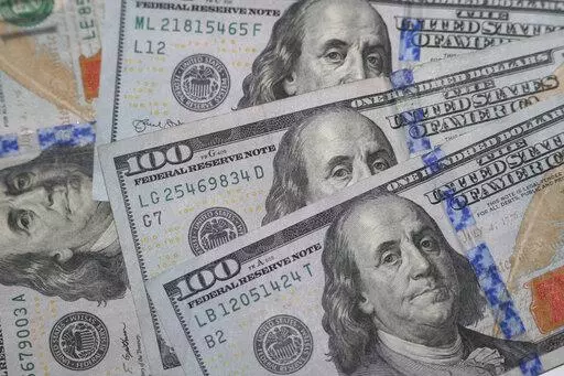 This Jan. 22, 2020, file photo shows the likeness of Benjamin Franklin on $100 bills in Dallas.  If you’re expecting a tax refund, you’re probably contemplating what to spend this newfound money on. There are several ways to use your windfall responsibly, but paying off debt could be the right option.  (AP Photo/LM Otero, File)