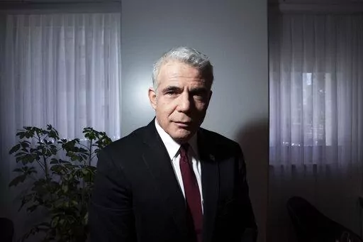 Israel's opposition leader Yair Lapid poses for a photo at his office in Tel Aviv, Israel, Thursday, May 21, 2020. Following the government's decision to dissolve parliament, Lapid, now foreign minister, is set to take office as caretaker prime minister until elections in the fall. It will be a critical test for Lapid, 58, who will try to convince Israelis he is worthy of the top office as he takes on a resurgent Netanyahu. (AP Photo/Oded Balilty, File)