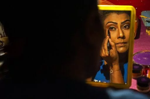 Prastuti Parashar, owner and lead actor of Awahan theater, prepares for a performance at Xetali village, east of Gauhati, India, Wednesday, April 6, 2022. Traveling theater groups in India's northeastern state of Assam are reviving the local art and culture scene after the COVID-19 pandemic forced a pause in their performances for a year and a half. “The public response has been very good. They love live performances. We have no competition from television and the digital boom,” said Parasha