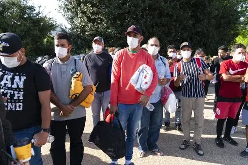 Migrants hold Red Cross blankets after arriving at Union Station near the U.S. Capitol from Texas on buses, April 27, 2022, in Washington. The District of Columbia has requested National Guard assistance to help stem a "growing humanitarian crisis" prompted by thousands of migrants that have been sent to Washington by governors in Texas and Arizona. (AP Photo/Jose Luis Magana, File)