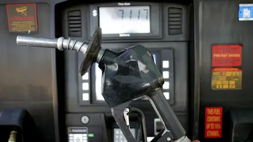 A gasoline pump is shown at a gas station Friday, June 10, 2022, in Salt Lake City.  With record-high gas prices, travelers can save money on summer road trips by considering alternatives. They can plan a trip to U.S. regions with lower-cost fuel, like the Midwest or South. If travelers need to rent a car, they might find affordable options by going to a cheaper car rental location or considering a car rental alternative like car sharing. With more hotels offering electric vehicle charging, rent