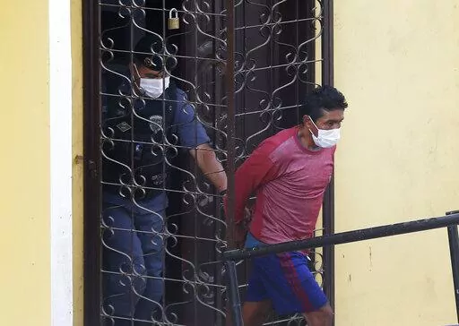 Oseney da Costa de Oliveira, is led out a courthouse by military and civil police officers in Atalia do Norte, Amazonas state, Brazil, June 15, 2022, after his arrest and that of his brother Amarildo, as a main suspect in the disappearance of British journalist Dom Phillips and Indigenous expert Bruno Pereira. Prosecutors presented their charges on July 21, 2022, outlining that two of the men — Amarildo da Costa Oliveira and Jefferson da Silva Lima — have confessed to the crime, while witnes