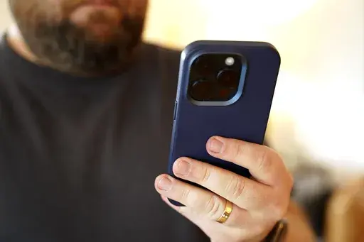 A person uses a cell phone on Saturday, July 13, 2024, in Los Angeles. The FBI Internet Crime Complaint Center reports that SIM-swapping complaints have increased more than 400% from 2018 to 2021. New federal regulations aimed at preventing port-out hijacking are under review, but it's not clear how far they will go in stopping the crime. When your own phone access is lost to a criminal, the very steps you once took to protect your accounts — such as two-factor authentication — can be used a