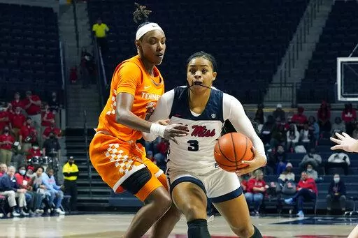 Mississippi guard Donnetta Johnson (3) dribbles around Tennessee guard Jordan Horston (25) during the second half of an NCAA college basketball game in Oxford, Miss., Sunday, Jan. 9, 2022. (AP Photo/Rogelio V. Solis)