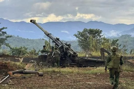 In this photo provided by the Kokang online media, members of an ethnic armed forces group, one of the three militias known as the Three Brotherhood Alliance, check weapons the group allegedly seized from Myanmar's army outpost on a hill in Hsenwi township in Shan state, Myanmar, on Nov. 24, 2023. A major offensive against Myanmar's military-run government by an alliance of three militias of ethnic minorities has been moving at lightning speed, inspiring resistance forces around the country to a