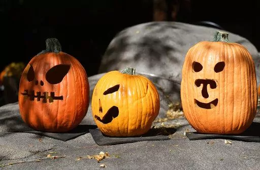 A display of pumpkins prepared for Halloween welcomes visitors at the Denver Zoo Tuesday, Oct. 18, 2022, in Denver. Forecasters predict that the warm weather will remain in place over the intermountain West through the week ahead. (AP Photo/David Zalubowski)