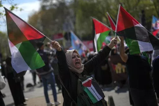 A woman waves flags in support of Palestinians in Gaza during a protest in Istanbul, Turkey, Friday, April 5, 2024. Turkey and Israel announced tit-for-tat trade barriers on Tuesday, April 9, 2024, as relations between them further deteriorated amid the war in Gaza. Turkey, a staunch critic of Israel’s military actions in Gaza, first announced that it was restricting exports of 54 types of products to Israel with immediate effect. The products include aluminum, steel, construction products, je