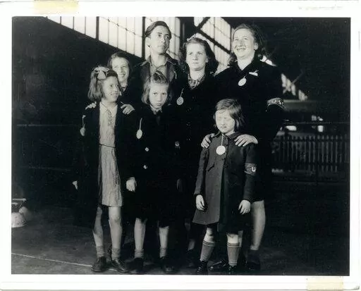 In this May 26, 1946, photo, Ginger Lane, bottom right, and her siblings arrive in New York City as Holocaust survivors who were hidden in a fruit orchard near Berlin by non-Jews. Their mother was killed at the death camp at Auschwitz. Lane has since made it her lifelong mission to educate others of this painful past. (Courtesy Ginger Lane via AP)