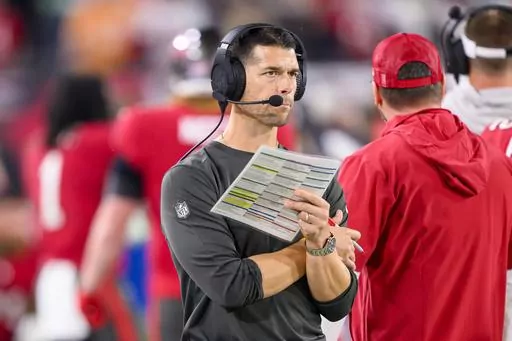 Tampa Bay Buccaneers offensive coordinator Dave Canales holds the play sheet on the sidelines during an NFL wild-card playoff football game against the Philadelphia Eagles, Monday, Jan. 15, 2024 in Tampa, Fla. The Carolina Panthers have agreed to hire Tampa Bay Buccaneers offensive coordinator Dave Canales as their new head coach, according to two people familiar with the situation. (AP Photo/Doug Murray, File)