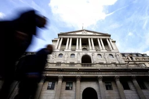 Pedestrians walk past The Bank of England in London, Thursday, Sept. 22, 2022. Britain's central bank is under pressure to make another big interest rate hike Thursday. Inflation in the United Kingdom is outpacing other major economies, but the U.S. Federal Reserve and other banks are moving faster to get prices under control. (AP Photo/Kirsty Wigglesworth)