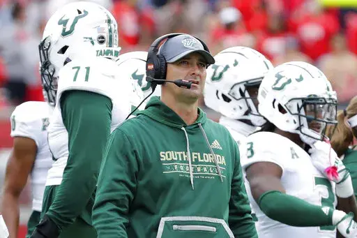 South Florida head coach Jeff Scott checks the scoreboard during a timeout in the first half of an NCAA college football game against Houston, Saturday, Oct. 29, 2022, in Houston. (AP Photo/Michael Wyke)