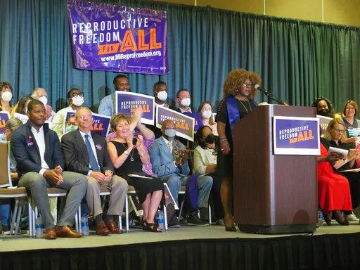 Elder Leslie Mathews, an organizer with Michigan United joins Leaders of the Reproductive Freedom for All campaign as they speak to supporters on Monday, July 11, 2022, in Lansing Mich., after turning in 753,759 signatures to qualify for Michigan's November ballot. (AP Photo/Joey Cappelletti)