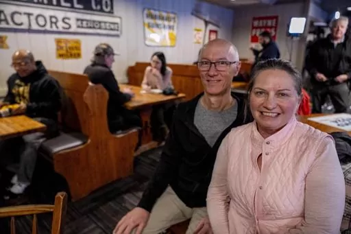 Cheryl and Dan Heffernen from Altoona, Iowa, pose for a photograph after listening to Donald Trump, Jr. speak at the Machine Shed in Urbandale, Iowa, Thursday, Jan. 11, 2024. (AP Photo/Andrew Harnik)