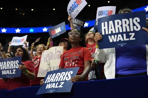 Supporters carry signs as Democratic presidential nominee Vice President Kamala Harris speaks at a campaign rally, Saturday, Aug. 10, 2024, in Las Vegas. (AP Photo/Julia Nikhinson, File)