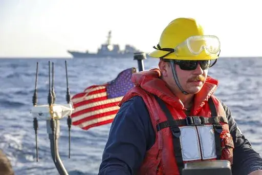 In this photo released by the U.S. Navy, Boatswain's Mate 2nd Class Hunter Pemberton, assigned to the USS Cole, takes part in an exercise on the Red Sea, March 29, 2022. Mohammed Abdul-Salam, Yemen's Houthi chief negotiator and spokesman, said late Friday, April 15, that the U.S. move in the Red Sea, which comes amid a cease-fire in the country's civil war, contradicts Washington’s claim of supporting the U.N.-brokered truce. (Mass Communication Specialist Seaman Christopher Stachyra/U.S. Navy