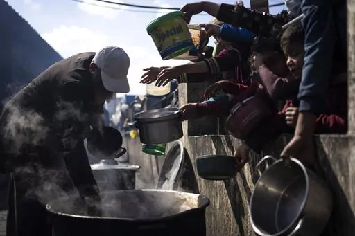 Palestinians line up for a free meal in Rafah, Gaza Strip, Friday, Feb. 16, 2024. President Joe Biden has proposed the delivery of humanitarian assistance to Gaza via a temporary port on the territory’s Mediterranean coast. (AP Photo/Fatima Shbair, File)