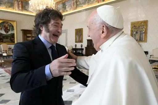 In this image distributed by Vatican Media, Argentine President Javier Milei, left, cheers at Pope Francis as they meet in the pontiff's studio at The Vatican for a private audience, Monday, Feb. 12, 2024. Milei, who will meet Italian President Sergio Mattarella and Italian Premier Giorgia Meloni later in the day, attended the canonization of the first Argentine female saint, María Antonia de Paz y Figueroa also known as "Mama Antula" in St. Peter's Basilica on Sunday. (Vatican Media via AP, HO