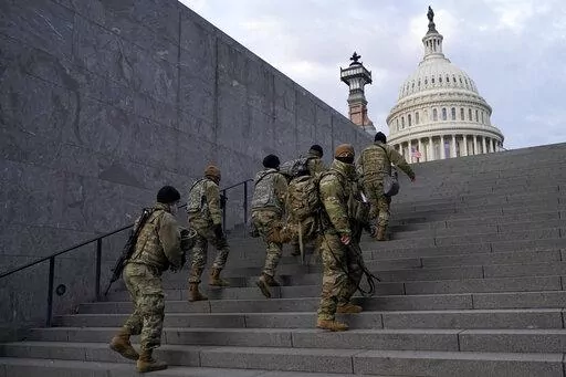 National Guard members take a staircase toward the U.S. Capitol building before a rehearsal for President-elect Joe Biden's Presidential Inauguration in Washington, Jan. 18, 2021. Soldiers are leaving the Army National Guard at a faster rate than they are enlisting, fueling concerns that in the coming years units around the country may not meet military requirements for overseas and other deployments. Officials say the number of soldiers retiring or leaving the Guard each month in the past year 