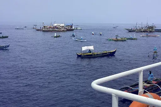 In this photo provided by the Philippine Coast Guard, fishing boats carrying activists and volunteers belonging to a nongovernment coalition called Atin Ito, Tagalog for This is Ours, pass by waters off Palauig Point, Zambales province, northwestern Philippines as they head towards Scarborough Shoal on Wednesday May 15, 2024. A flotilla of about 100 mostly small fishing boats led by Filipino activists sailed Wednesday to a disputed shoal in the South China Sea, where Beijing's coast guard and su