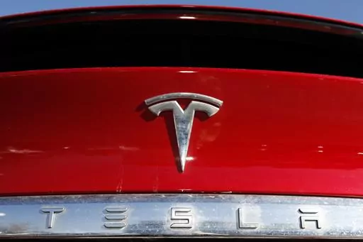In this Feb. 2, 2020, file photo, the Tesla company logo is shown in Littleton, Colo. Tesla is recalling nearly all of the vehicles it has sold in the U.S. because some warning lights on the instrument panel are too small. Documents posted Friday, Feb. 2, 2024 by U.S. safety regulators say the recall will be done with an online software update. (AP Photo/David Zalubowski, File)