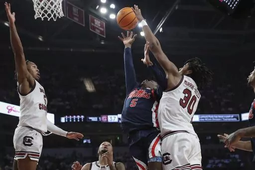 Mississippi guard Jaylen Murray (5) scores and is fouled by South Carolina forward Collin Murray-Boyles (30) during the first half of an NCAA college basketball game Tuesday, Feb. 6, 2024, in Columbia, S.C. (AP Photo/Artie Walker Jr.)