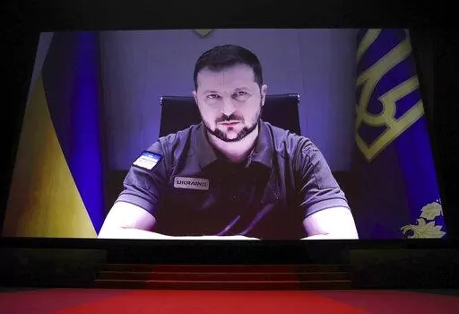 President of Ukraine Volodymyr Zelenskyy appears via remote during the opening ceremony of the 75th international film festival, Cannes, southern France, Tuesday, May 17, 2022. (Photo by Vianney Le Caer/Invision/AP)
