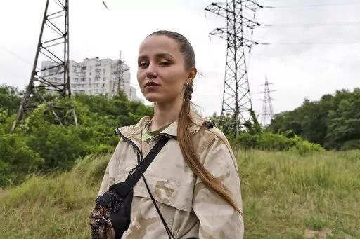 Instructor Ilona Khomenko looks on during a first aid training to master the MARCH algorithm according to the NATO protocol, in Kyiv, Ukraine, Monday, July 11, 2022. Khomenko’s life changed on May 23, when her husband died fighting the near Severodonetsk in eastern Ukraine. Now she keeps him close by helping to train soldiers and civilians how to survive on the battlefield. (AP Photo/Vasilisa Stepanenko)