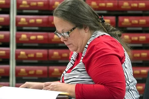 In this Nov. 6, 2018, file photo, Kim Davis, the county clerk for Rowan County in Kentucky, works with the county election board on Election Day, in Morehead, Ky.  A federal judge has ruled, Friday, March 18, 2022,  that the former Kentucky clerk violated the constitutional rights of two same-sex couples after she wouldn't issue them marriage licenses — a refusal that sparked international attention and briefly landed her in jail in 2015.  (AP Photo/John Flavell, File)