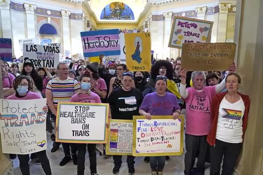 Trans-rights activists protest outside the House chamber at the Oklahoma Capitol before the State of the State address, Feb. 6, 2023, in Oklahoma City. On Monday, May 1, Oklahoma became the latest state to ban gender-affirming medical care for minors as Republican Gov. Kevin Stitt signed a bill that makes it a felony for health care workers to provide children with treatments that can include puberty-blocking drugs and hormones. (AP Photo/Sue Ogrocki, File)
