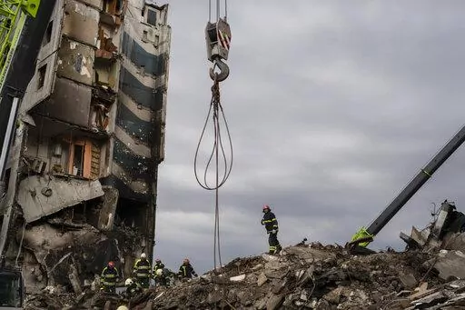 Firefighters work on a destroyed apartment building in the town of Borodyanka, Ukraine, on Saturday, April 9, 2022. Russian troops occupied the town of Borodyanka for weeks. Several apartment buildings were destroyed during fighting between the Russian troops and the Ukrainian forces in the town around 40 miles northwest of Kiev. (AP Photo/Petros Giannakouris)