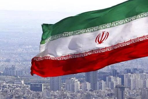 Iran's national flag waves in Tehran, Iran, March 31, 2020. Iranian media reported on Wednesday July 6, 2022, that the country’s paramilitary Revolutionary Guard has accused the deputy ambassador of the United Kingdom and other foreigners in the country of “espionage” and taking soil samples from prohibited military zones. (AP Photo/Vahid Salemi, File)