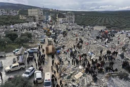 Civil defense workers and residents search through the rubble of collapsed buildings in the town of Harem near the Turkish border, Idlib province, Syria, Monday, Feb. 6, 2023. (AP Photo/Ghaith Alsayed, File)