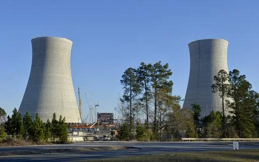 The cooling towers of the still under construction Plant Vogtle nuclear energy facility in Waynesboro, Ga., Friday, March 22, 2019.   One of the owners of the plant announced Saturday, June 18, 2022, that it was freezing its costs and forcing Georgia Power Co. to assume all future overruns, giving up a share of its ownership to Georgia Power.  (Michael Holahan/The Augusta Chronicle via AP)